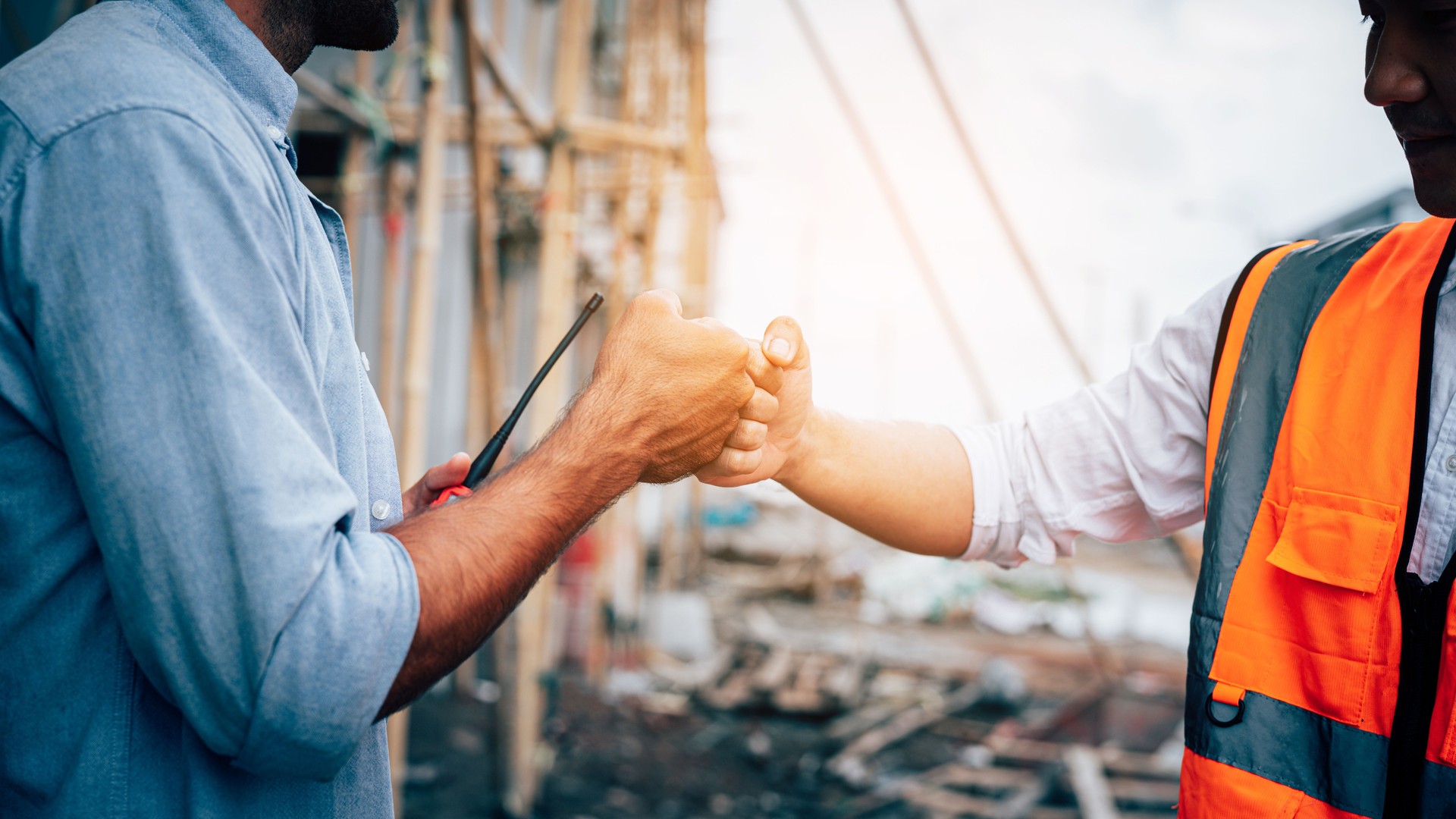 Portrait of Engineer construction workers shaking hands with deals on construction site.