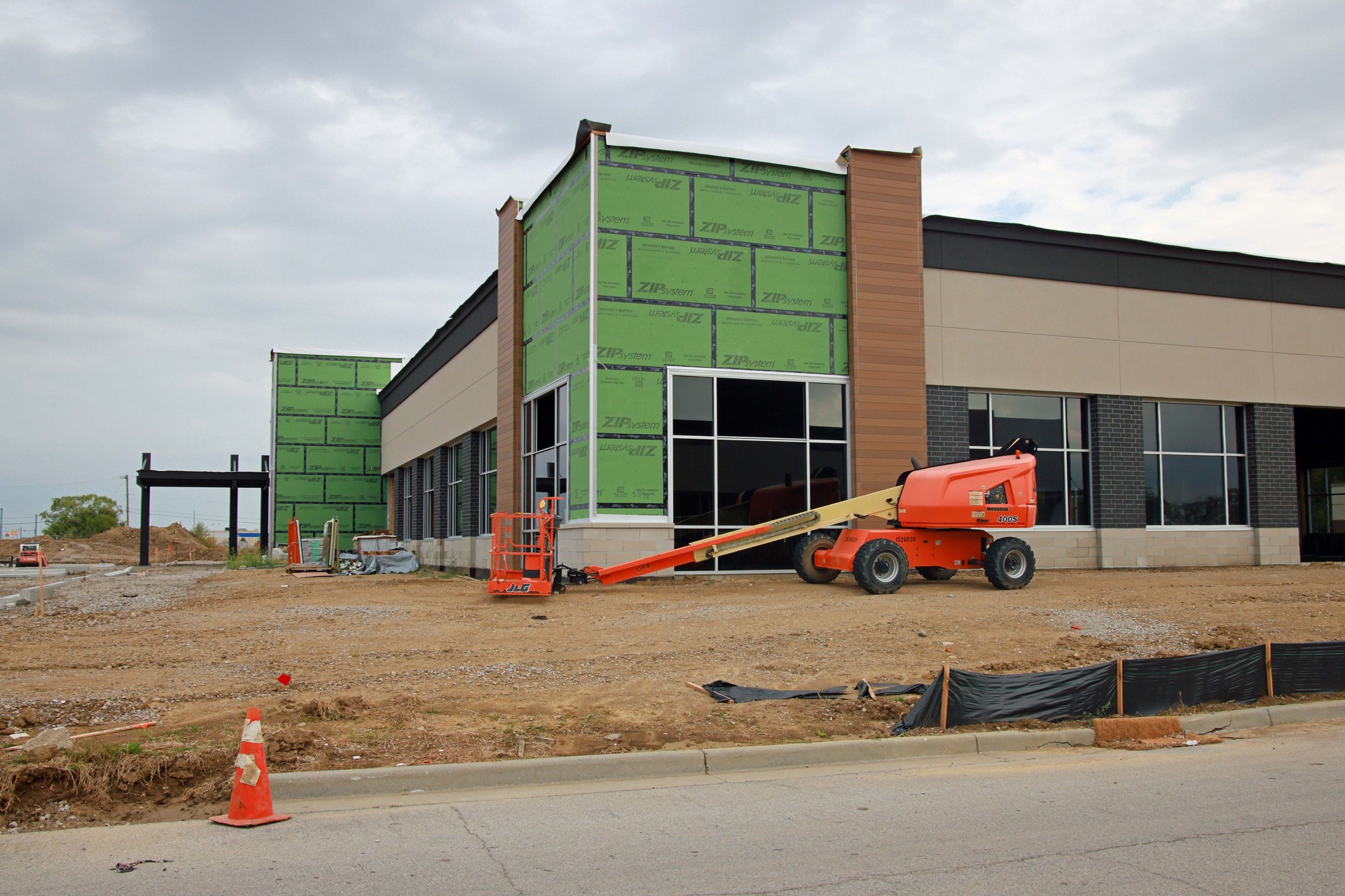 A commercial real estate building under construction on a cloudy day