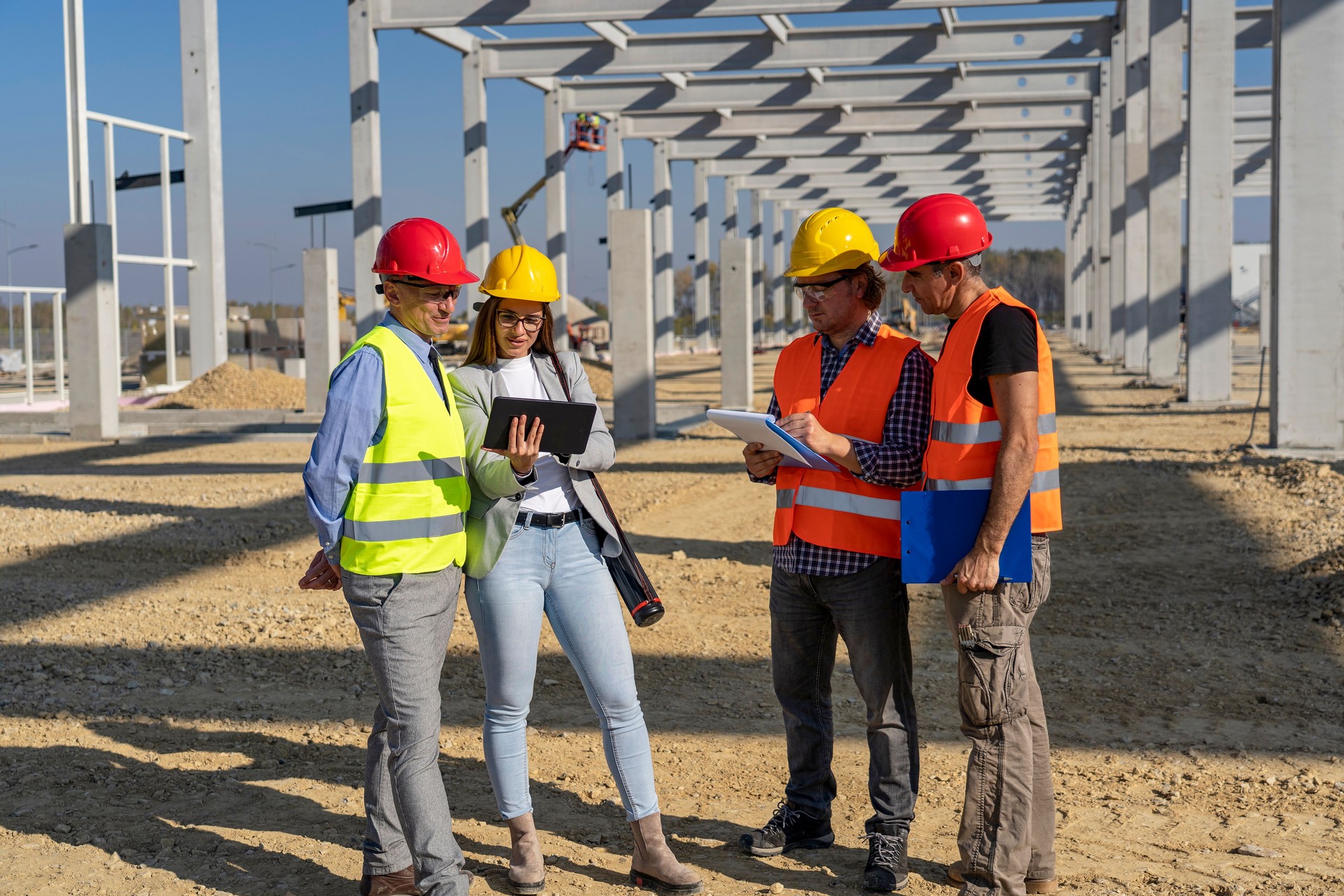 Construction Project Manager And His Team Discuss A Project On Construction Site